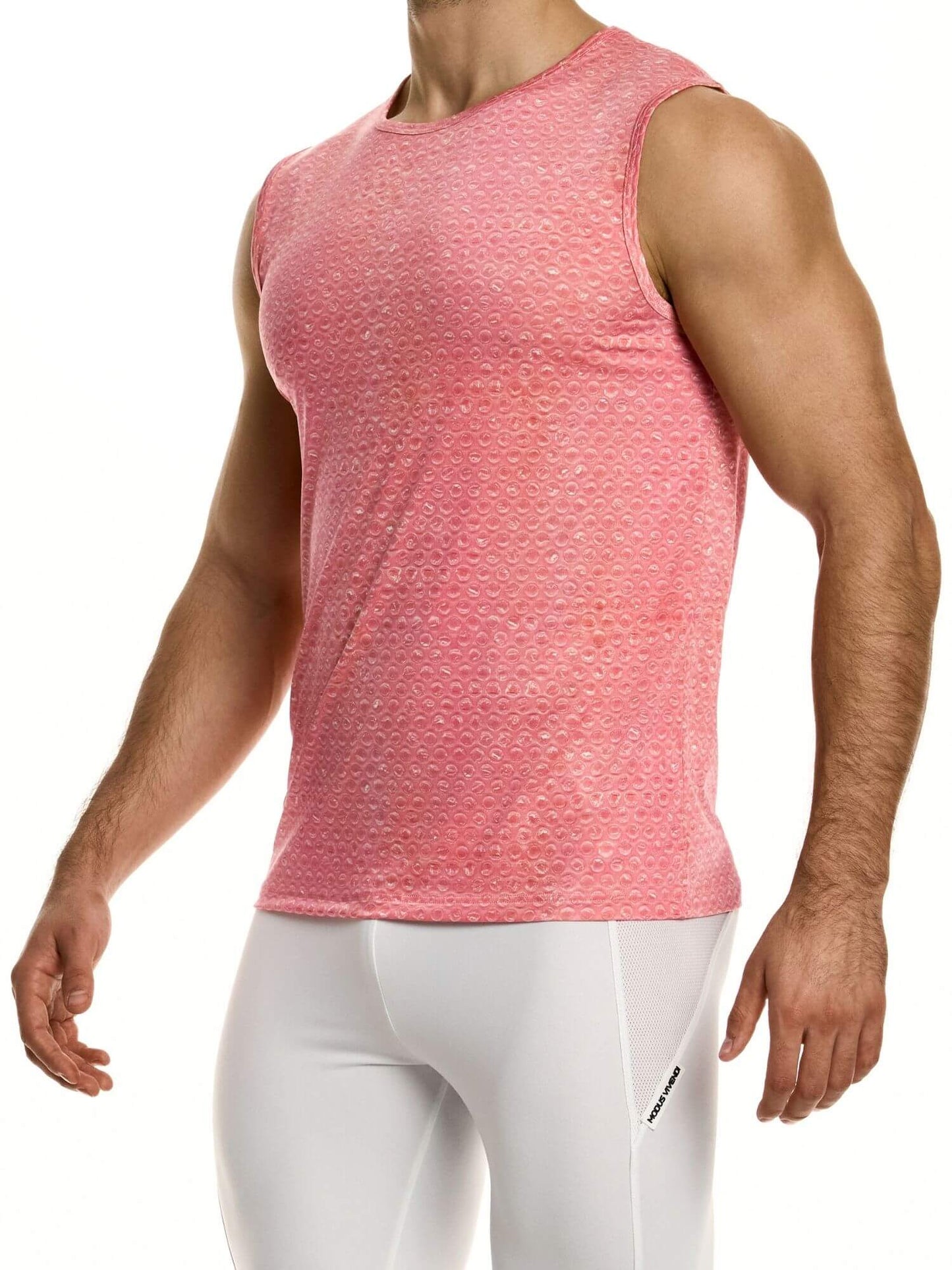Person wearing a pink sleeveless shirt and white pants on a white background