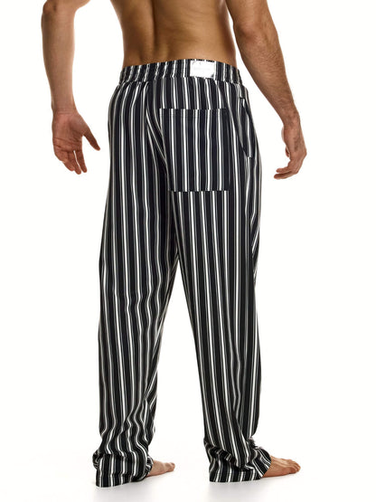 Black and white striped pants worn by a person on a white background