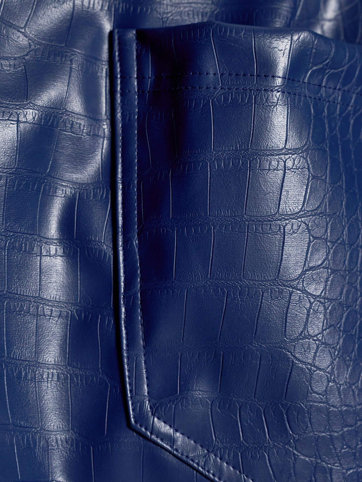 Close-up of blue crocodile-textured fabric from the Modus Vivendi Croco collection