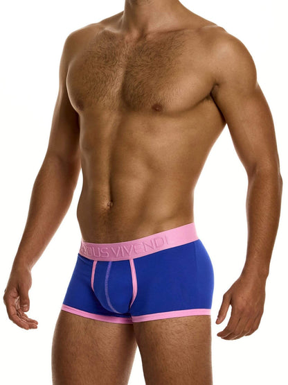 Man wearing blue boxer briefs with pink waistband on a white background