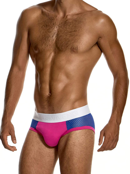 A man wearing low-rise men's briefs with a white waistband, blue mesh side panels, and a bright pink front panel, shown against a plain white background.