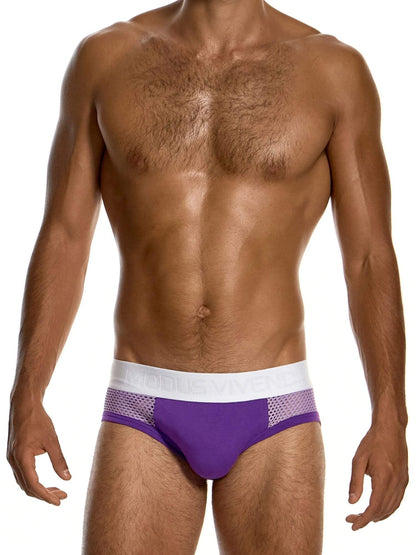 A man wearing a pair of purple athletic briefs with a white waistband and mesh side panels, shown from the chest down against a white background.