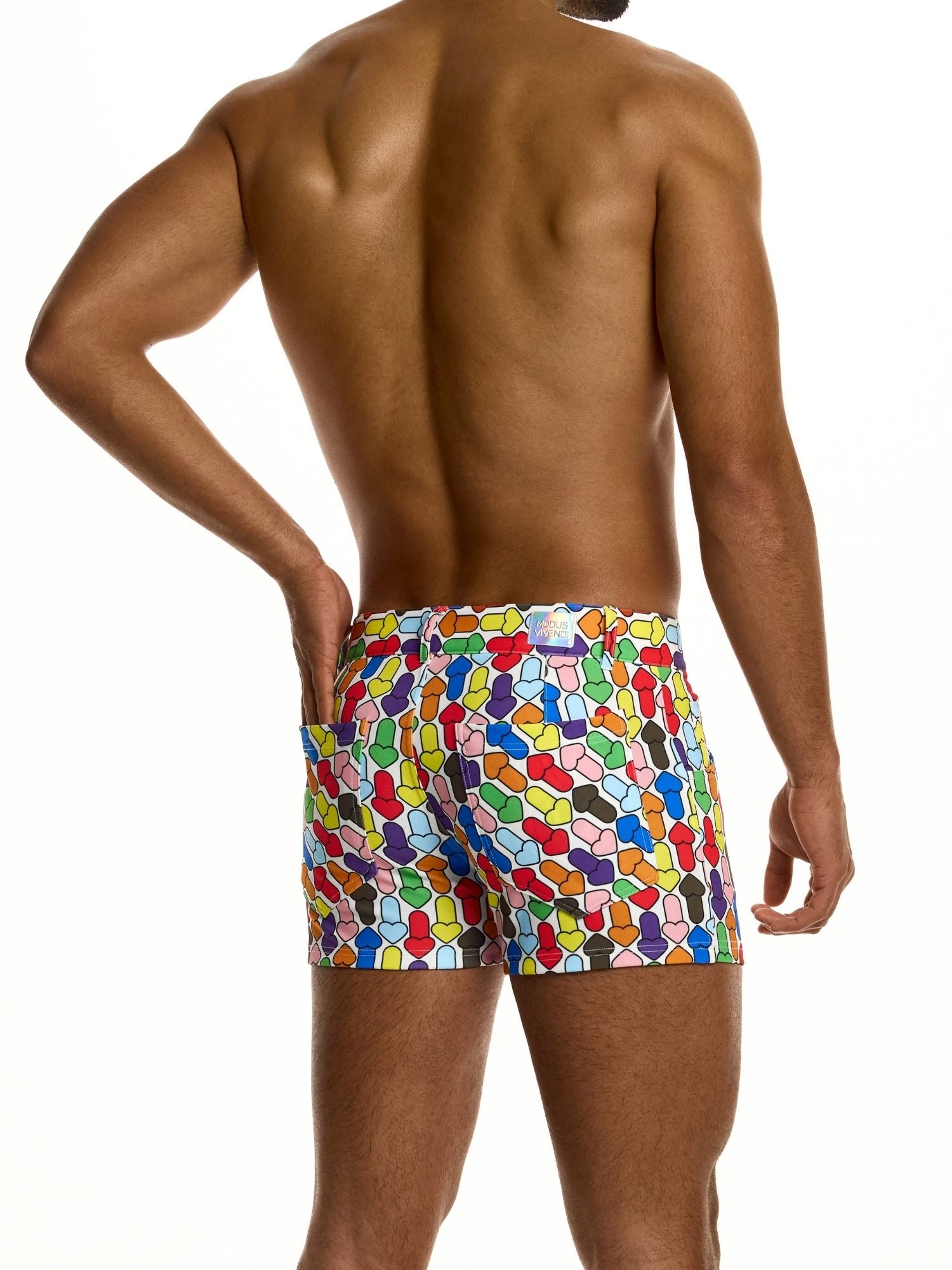 Man wearing colorful patterned shorts on a white background