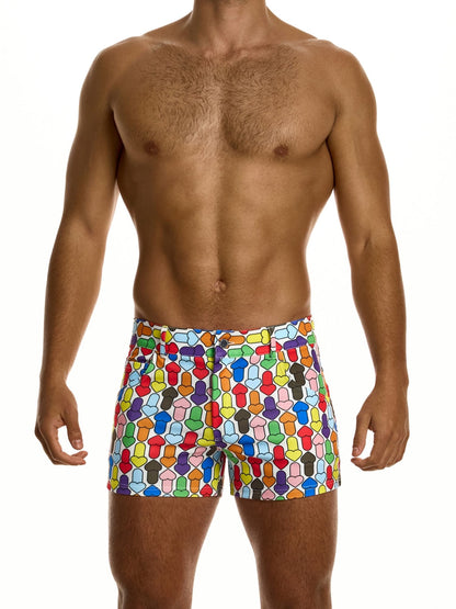 Man wearing colorful geometric patterned shorts on a white background