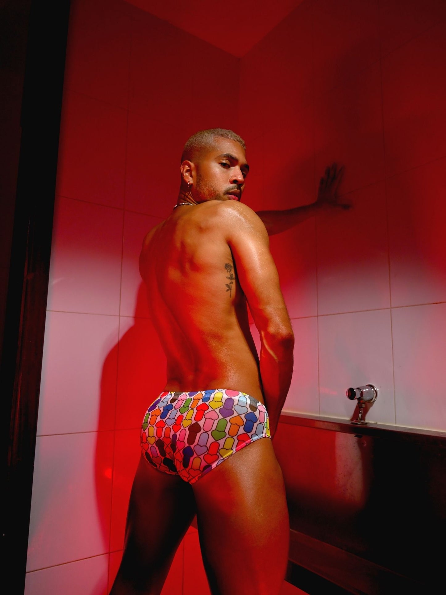 Man wearing colorful underwear in a bathroom setting