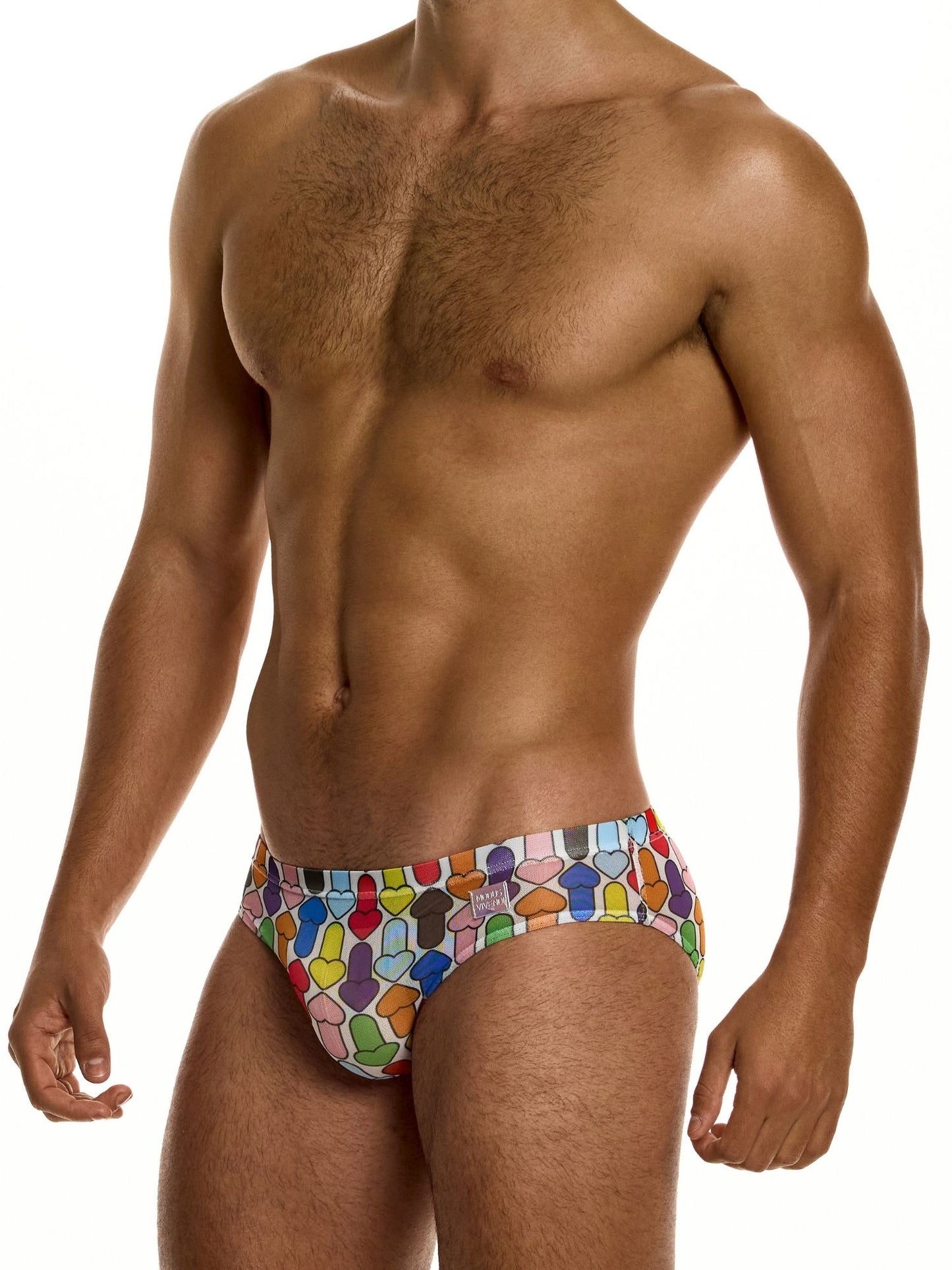 Man wearing a colorful patterned brief on a white background