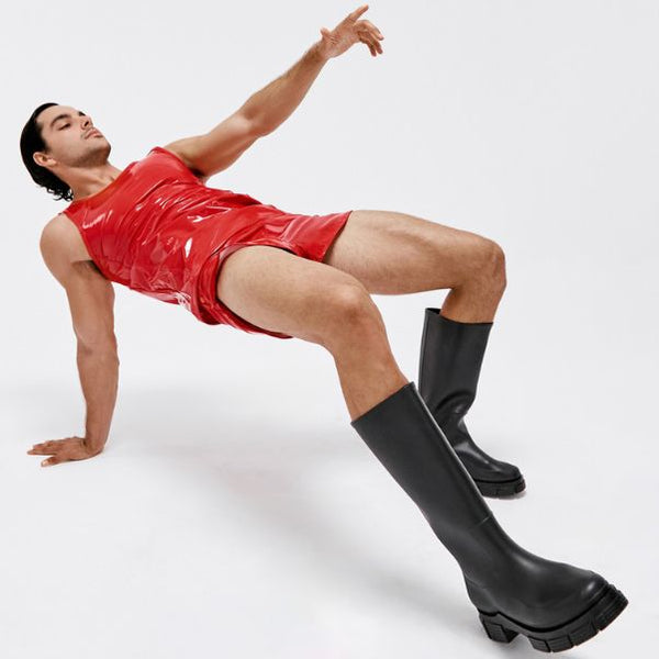 Model wearing Modus Vivendi red vinyl latex clothing outfit