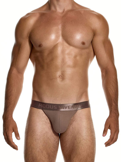 A muscular male model wearing a brown low-rise brief from Modus Vivendi, shown from the chest down against a white background.