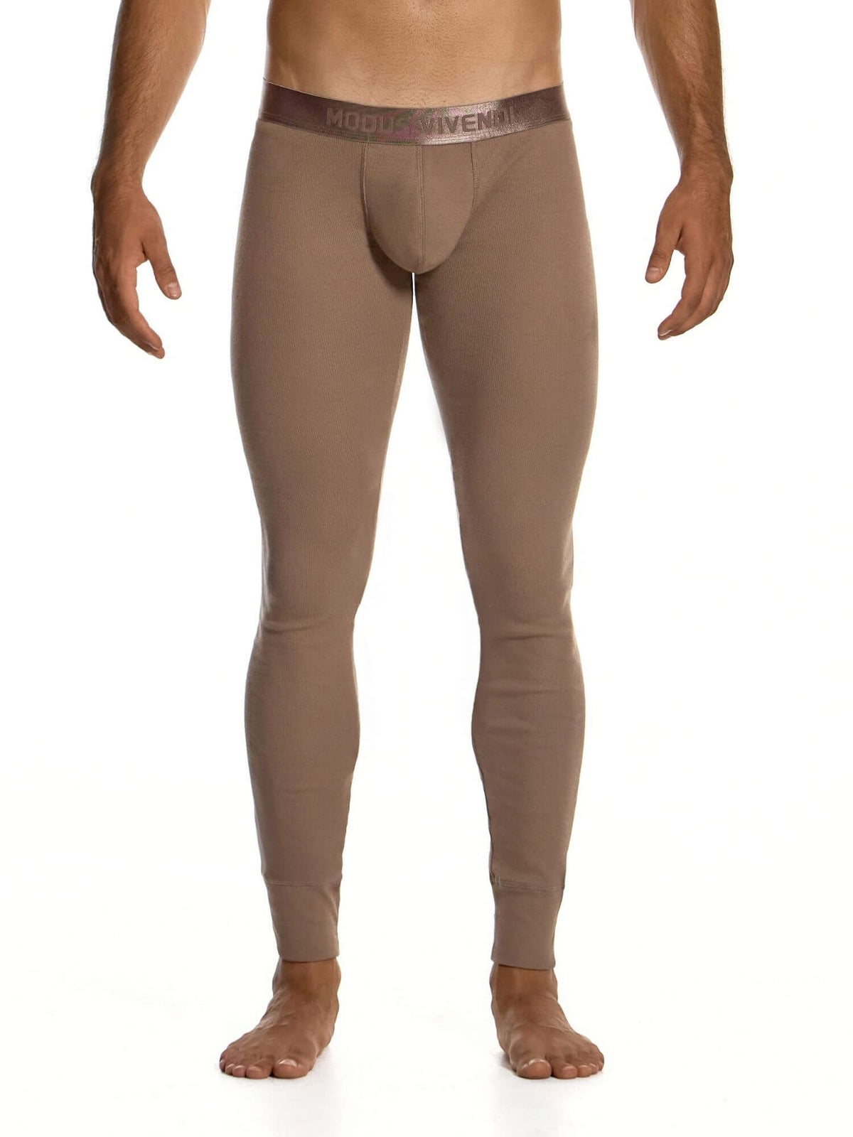 A man's lower body wearing tight-fitting, full-length brown compression or base-layer leggings with a visible waistband 