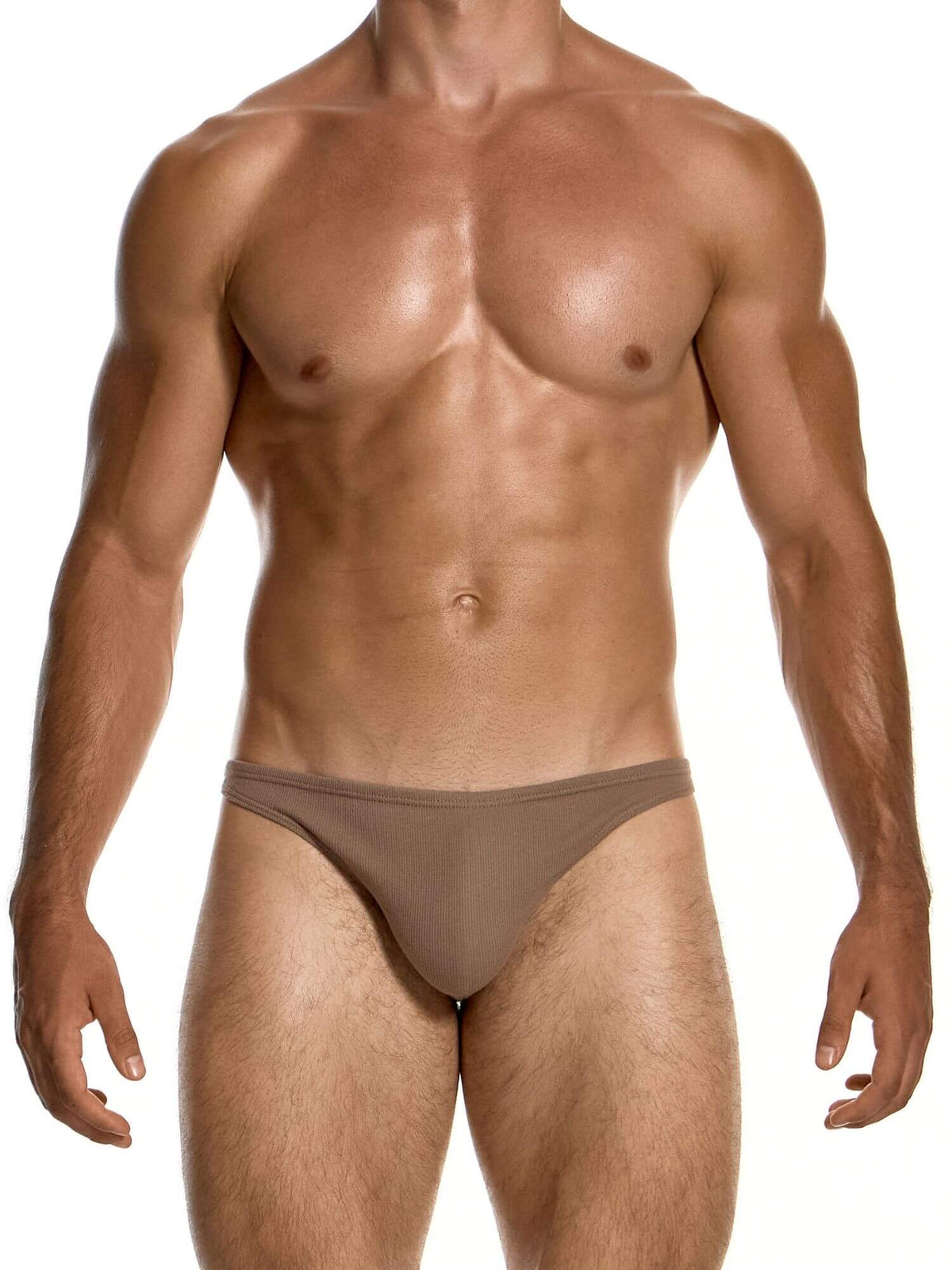 A muscular male model wearing a low-rise, minimal-cut brown brief against a solid white background.