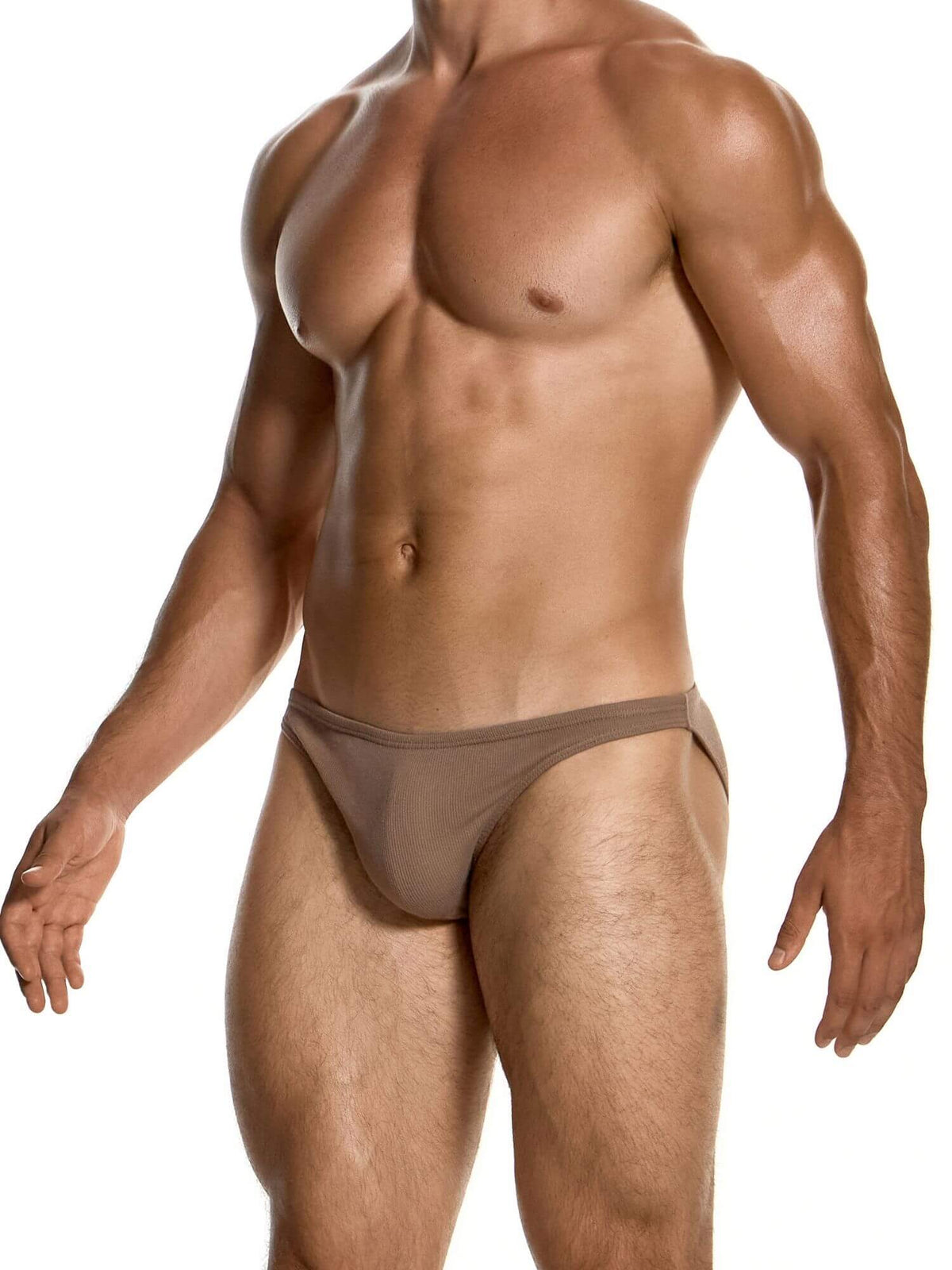 A muscular male model wearing a low-rise, solid taupe-brown brief against a clean white background.