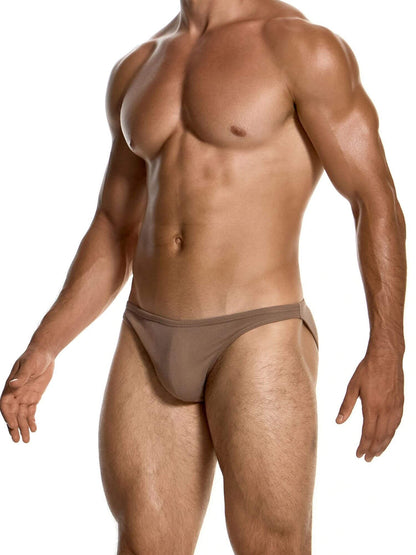 A muscular male model wearing a low-rise, solid taupe-brown brief against a clean white background.