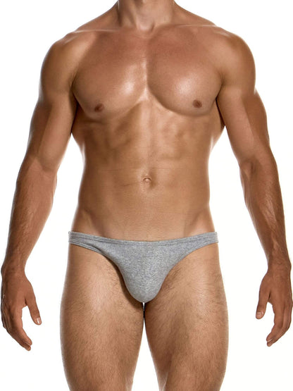 A muscular male model wearing a low-rise, heather gray men's briefs, shown from the chest down against a solid white background.