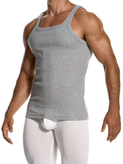 A muscular man wearing a heather gray ribbed tank top and white compression pants, shown from the neck down against a plain white background.