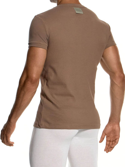 A man wearing a fitted short-sleeve crew-neck t-shirt in a warm taupe-brown color, shown from the back. The shirt has a small rectangular brand patch on the upper back.