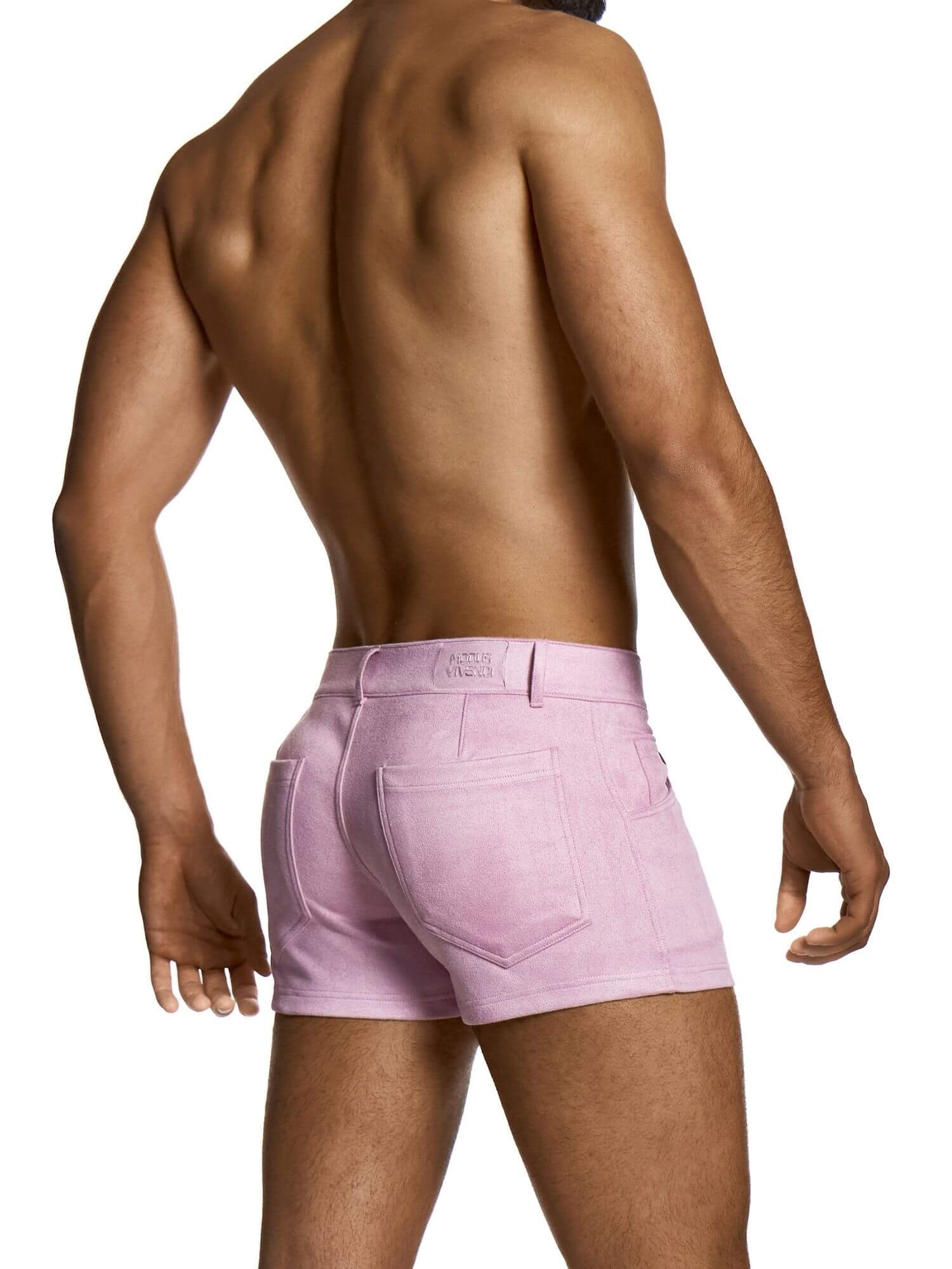 Person wearing light pink mini shorts on a white background