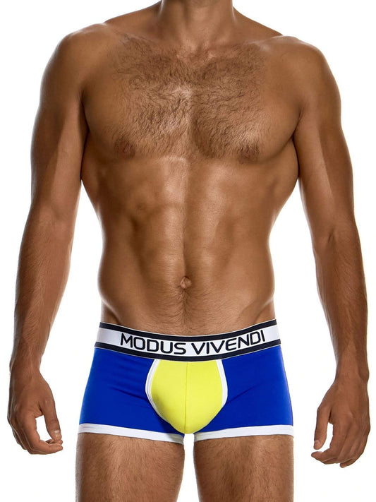 A male model wearing Modus Vivendi boxer briefs with a distinctive yellow and blue design, shown from the chest down against a white background.