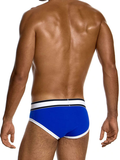 Rear view of a man wearing bright blue men's briefs with a white and black elastic waistband, set against a plain white background.