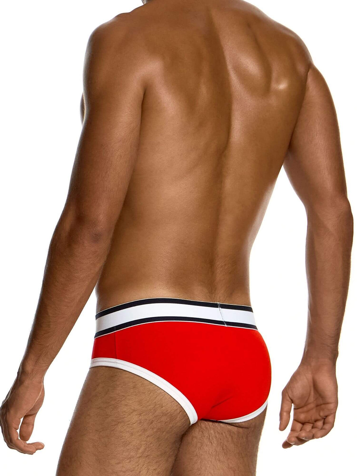 Rear view of a man wearing bright red swim briefs with a white and black striped waistband, against a plain white background.