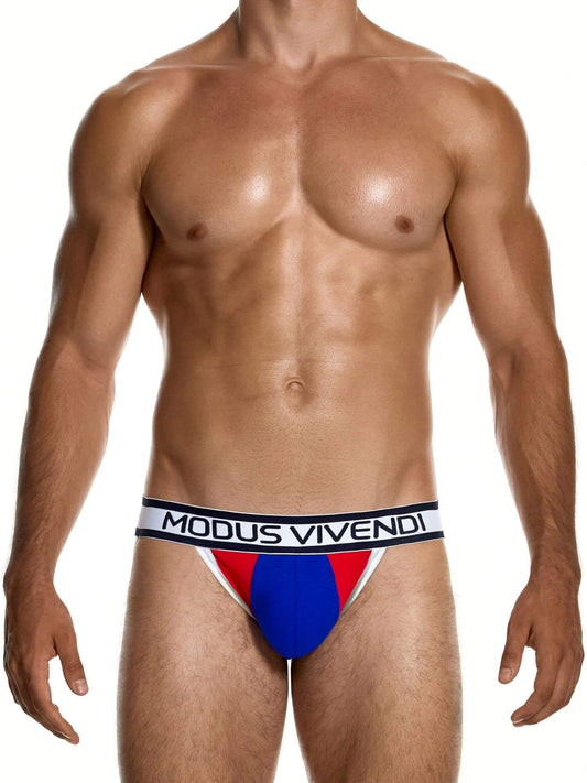A male model wearing Modus Vivendi jockstrap underwear with a red, blue, and white color-blocked design and a white waistband with black lettering.
