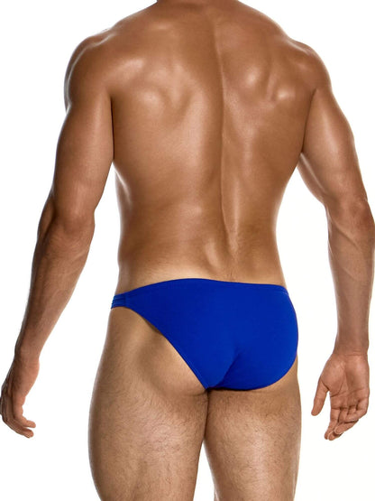 Rear view of a muscular male model wearing bright royal blue swim briefs against a plain white background.
