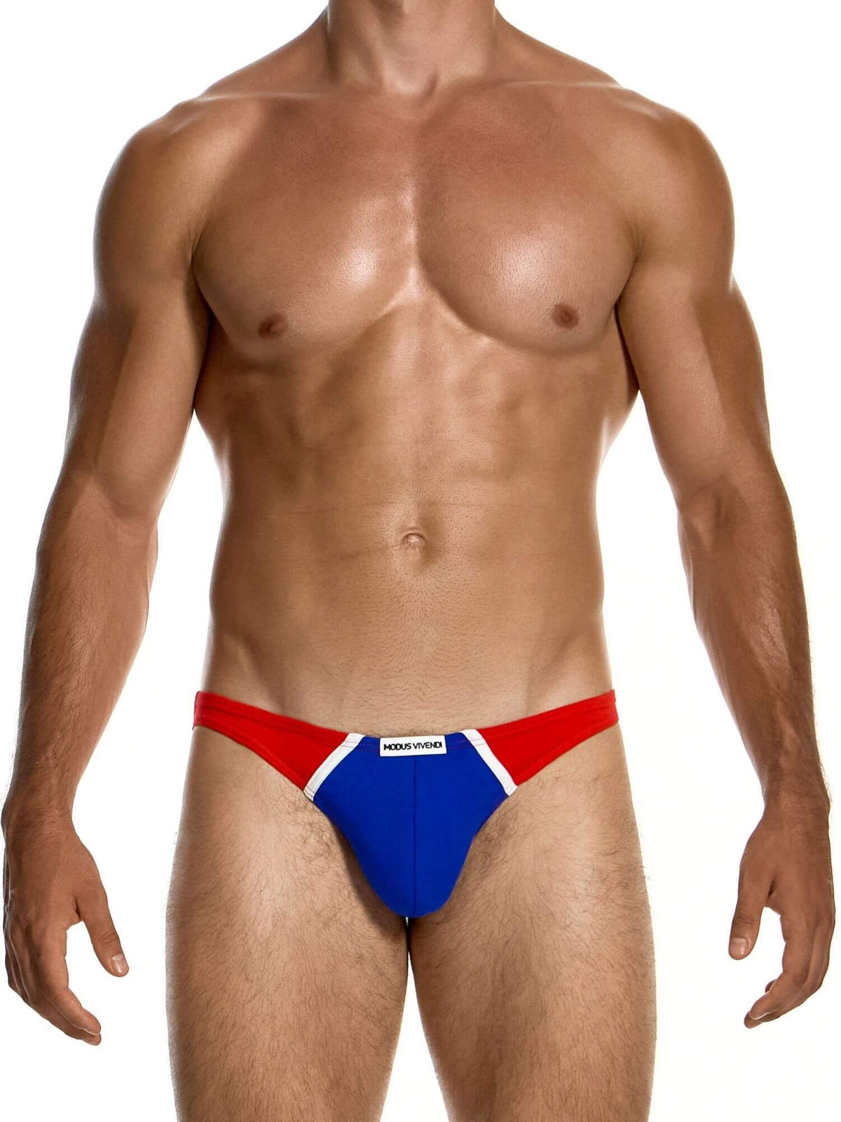 A muscular male model wearing low-rise swim briefs with a red, white, and blue design, featuring a white brand label that reads MODUS VIVENDI