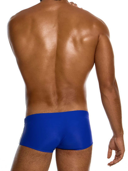 Man wearing blue swim trunks on a white background