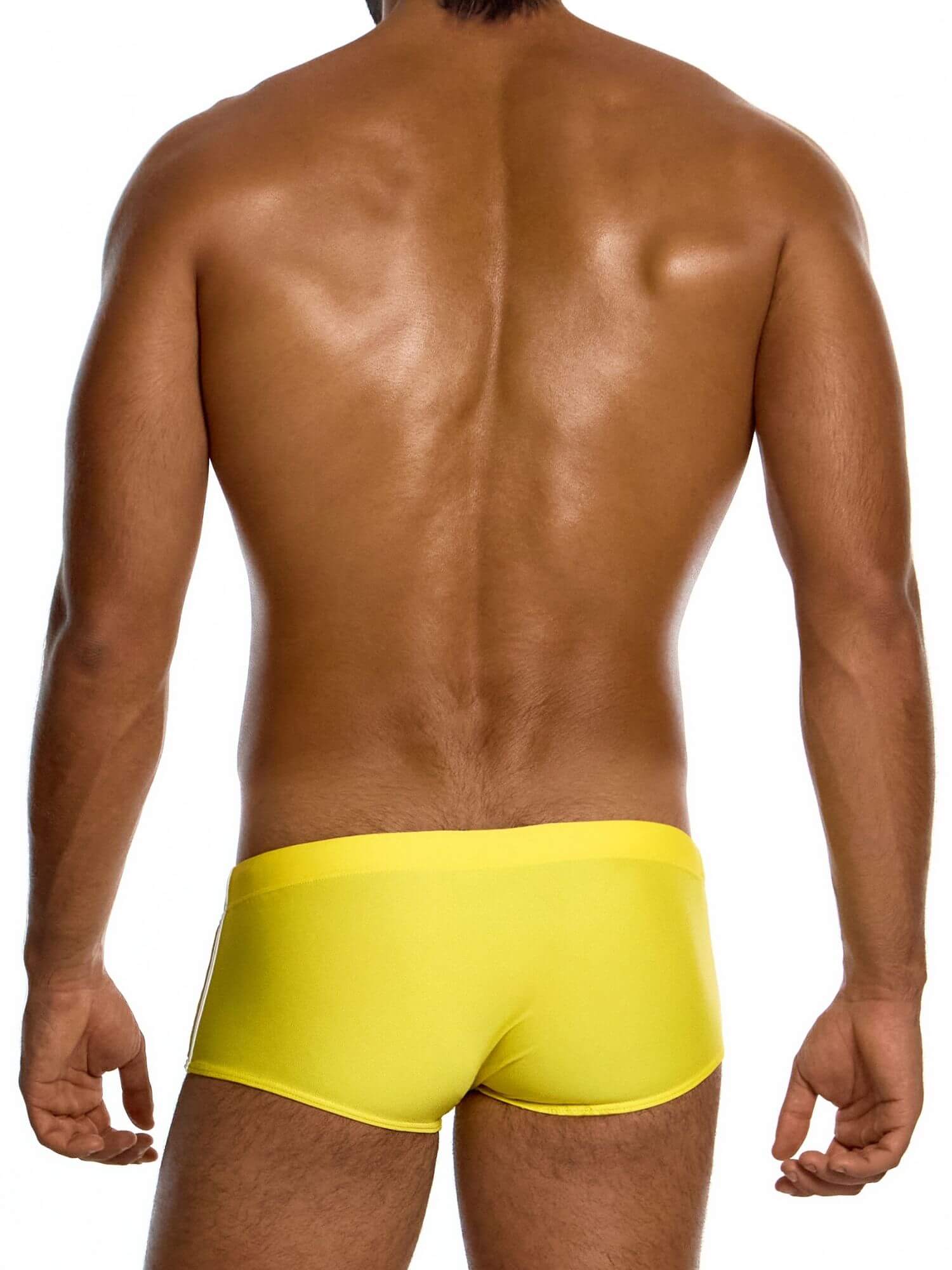 Person wearing bright yellow swim trunks on a white background