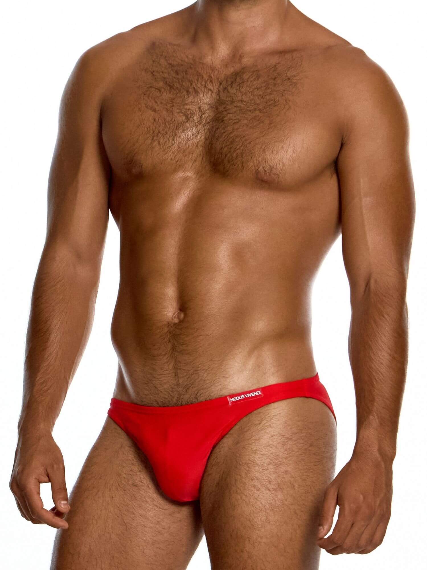 Man wearing a red men's swim bikini on a white background