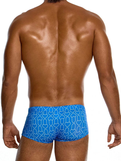 Man wearing blue swim trunks with a geometric pattern on a white background