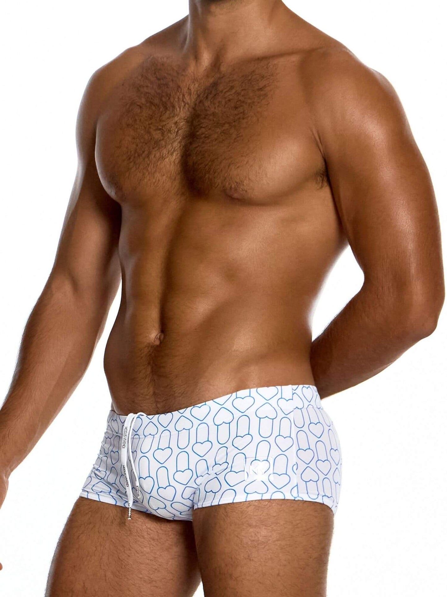 Man wearing white swimwear with geometric pattern on a plain background