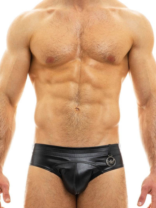 A man wearing a red leather-look brief with a low-rise waist and metallic Modus Vivendi logo.