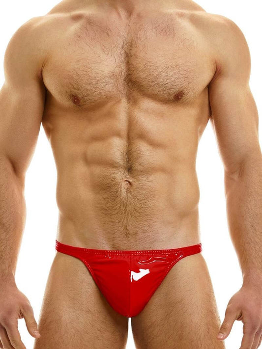 A man wearing a pink PVC thong with a low-rise elasticated waistband and a metallic 'Modus Vivendi' tag on the back.
