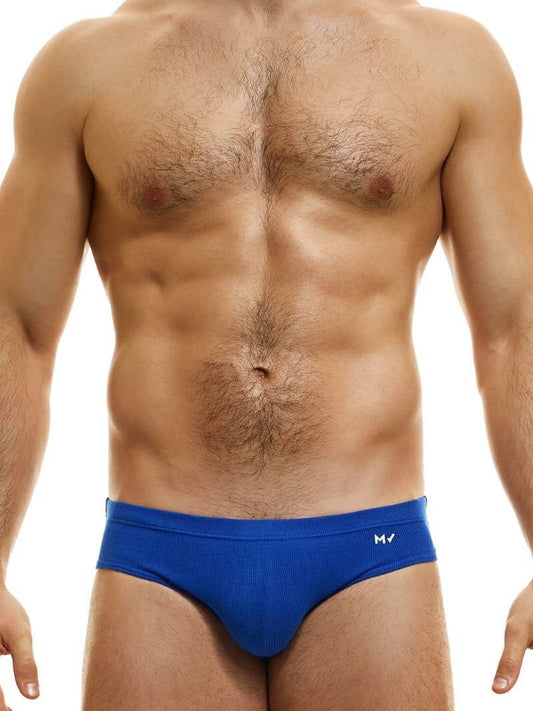 This image displays the MODUS VIVENDI Peace Classic Brief, modeled in a striking neon blue color. The briefs are designed with a low-rise waistband that ensures a modern and comfortable fit.