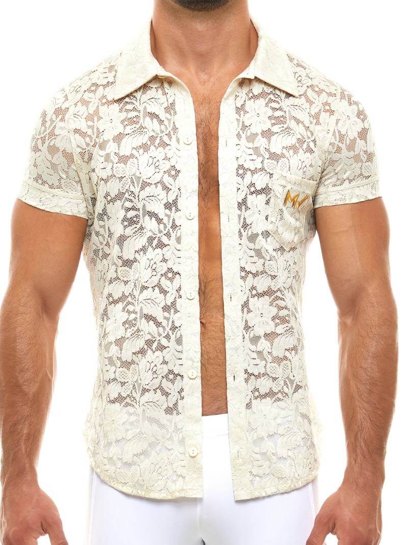 Man wearing a white lace shirt with a blurred background