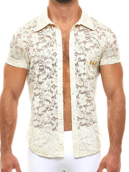 Man wearing a white lace shirt with a blurred background