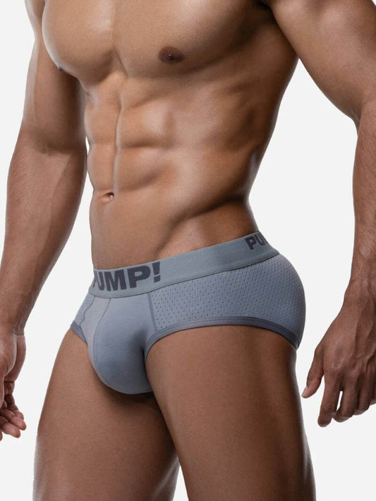 Man wearing a gray men's underwear with 'Pump!' branding on a white background