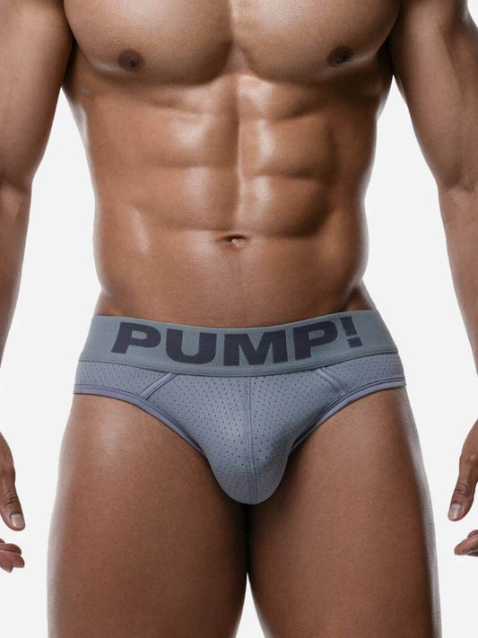 Man wearing a gray men's underwear with 'PUMP!' branding on a white background
