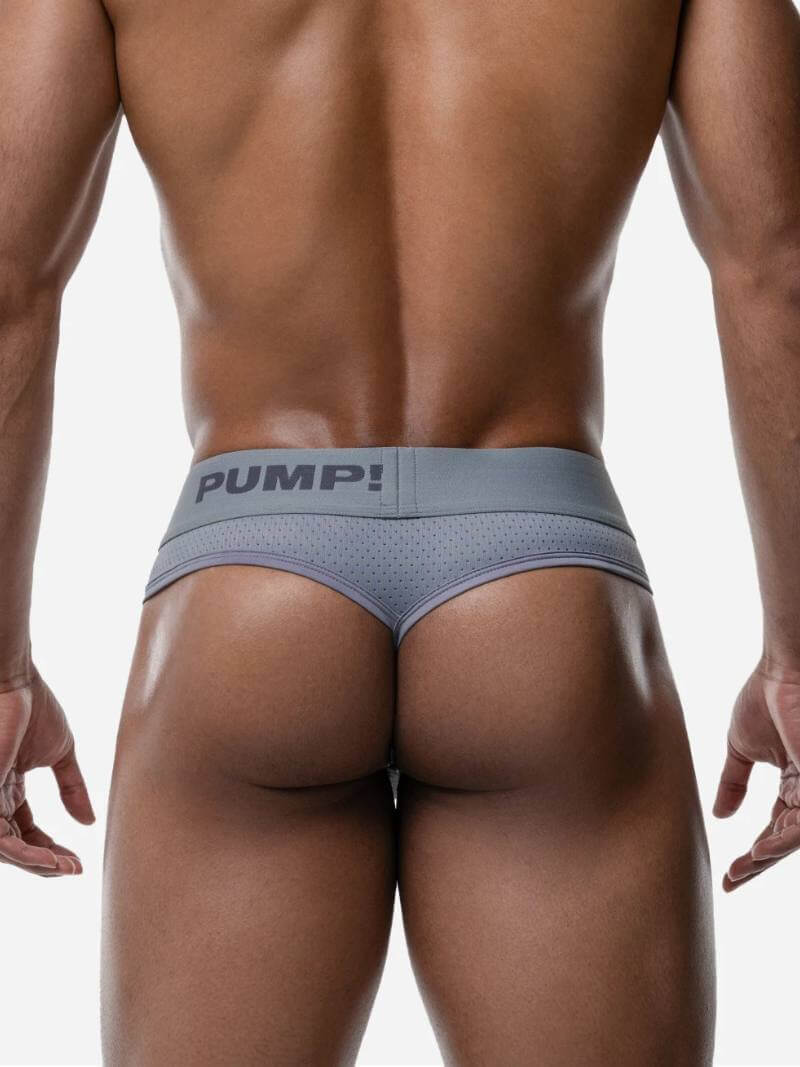 Person wearing a gray men's underwear with 'PUMP!' branding on a white background