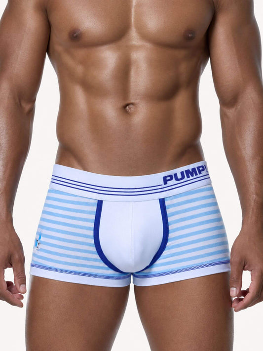 A close-up of a muscular male model wearing boxer briefs with light blue and white horizontal stripes, a white waistband with blue stripes and the brand name 'PUMP!' in blue, and a blue front pouch.