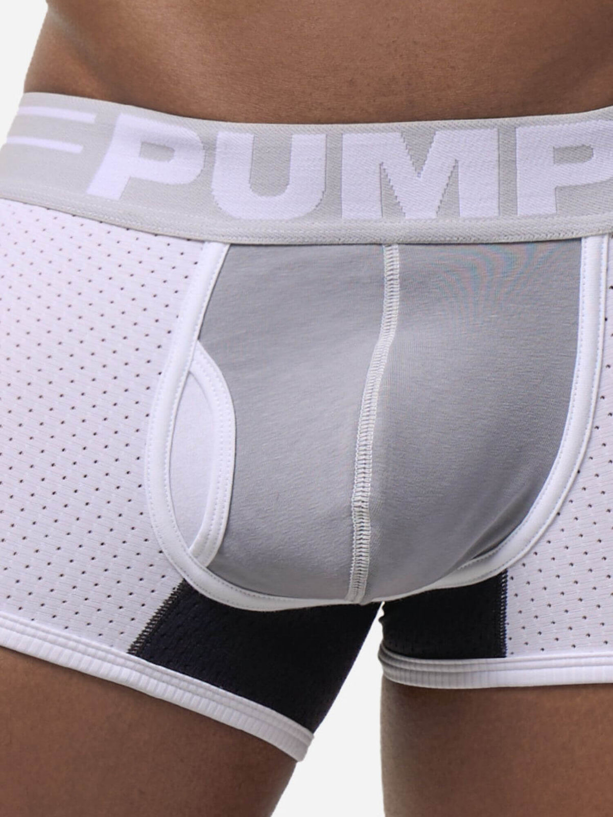 Close-up of a model wearing white and gray athletic boxer briefs with a black leg panel and a wide gray waistband featuring the brand name PUMP.