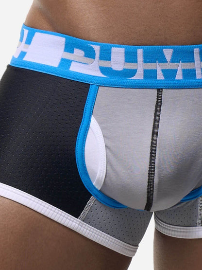 Close-up of a person wearing men's boxer briefs with a black perforated side panel, light gray front panel, white leg opening trim, and a bright blue waistband with a white logo.