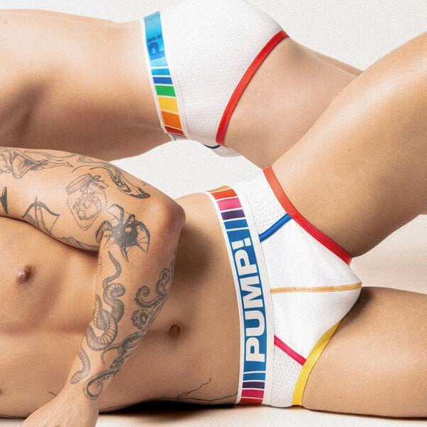 Person wearing colorful underwear with 'PUMP!' branding on a neutral background