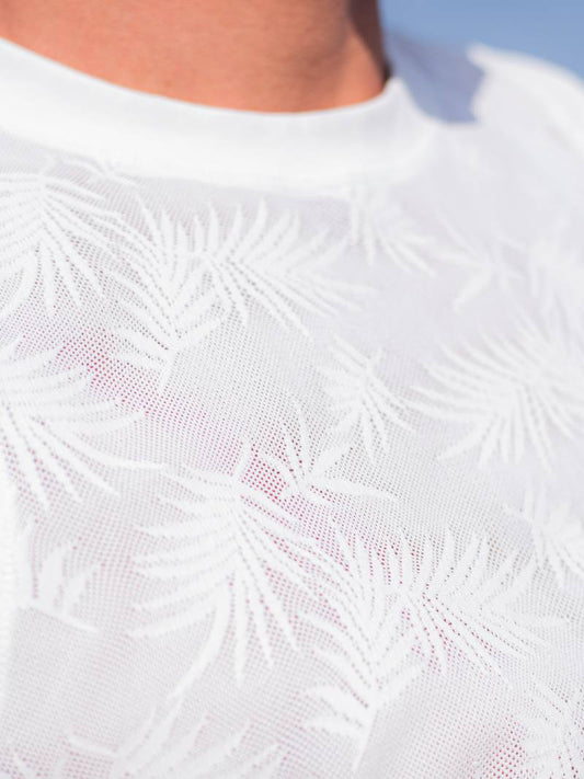 White textured t-shirt worn by a person on a white background