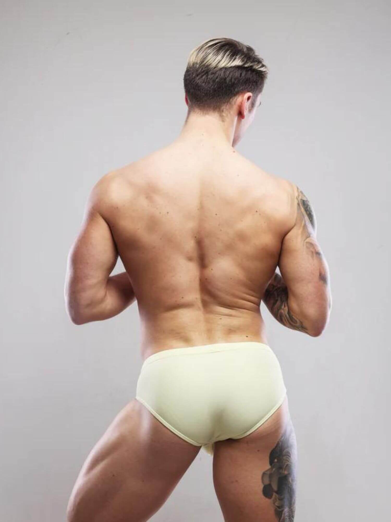 Man wearing light yellow sukrew swimwear