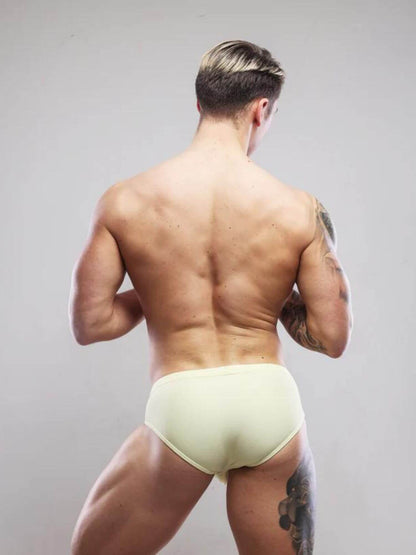 Man wearing light yellow sukrew swimwear