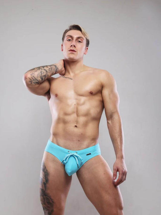 Man wearing SUKREW turquise swimwear