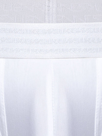 Close-up of a white underwear or garment waistband with a repeating tonal SUKREW logo pattern, shown against matching white fabric.