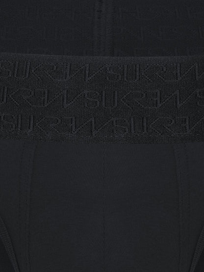 Close-up of a black ribbed knit garment with a wide waistband featuring an embossed repeating SUKREW logo pattern.