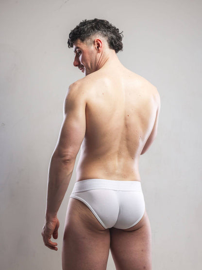 Man wearing a white men's underwear on a plain background